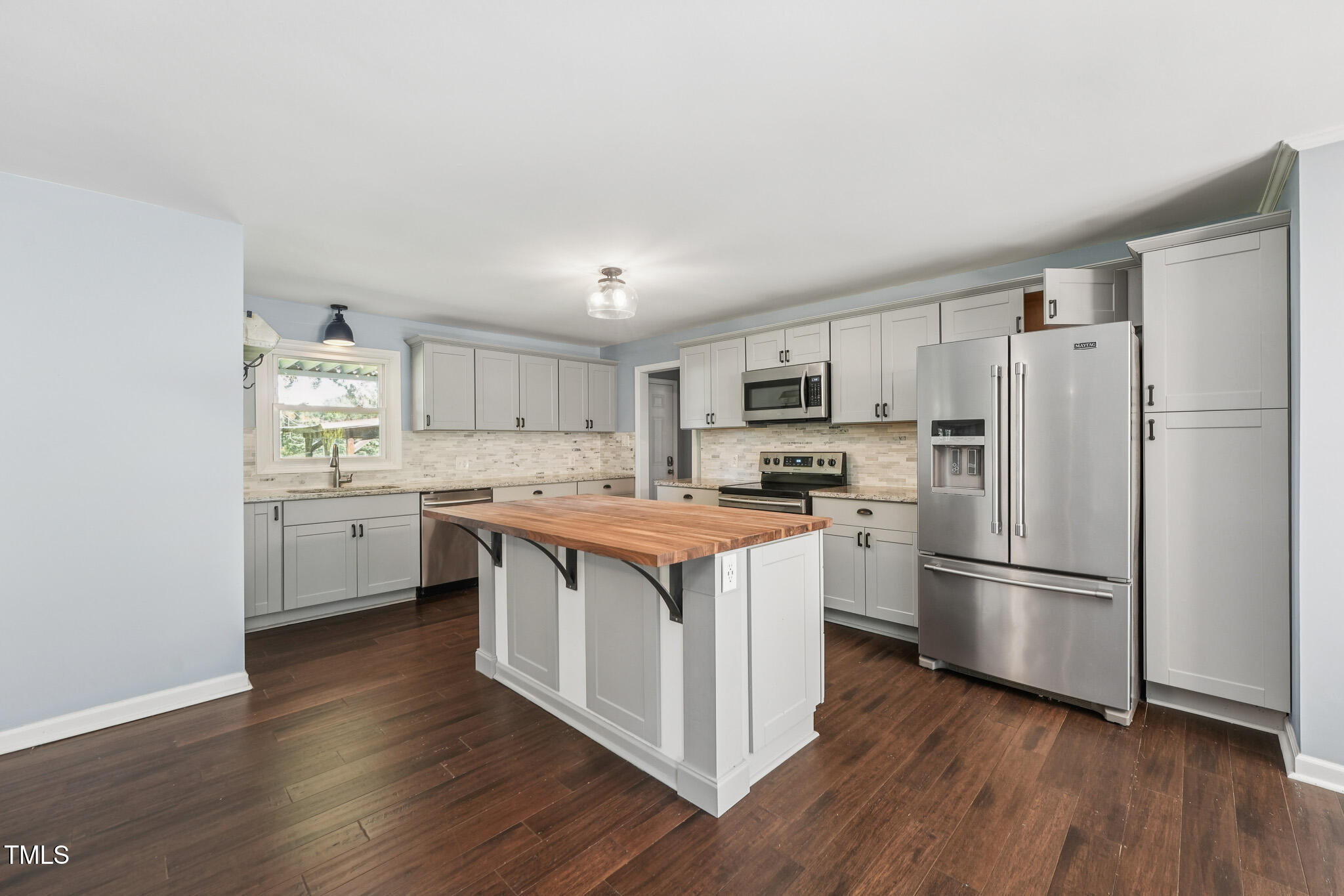 312 Mason Road Durham, NC 27712 - Photo 3 of 25 a kitchen with stainless steel appliances a sink cabinets and wooden floor