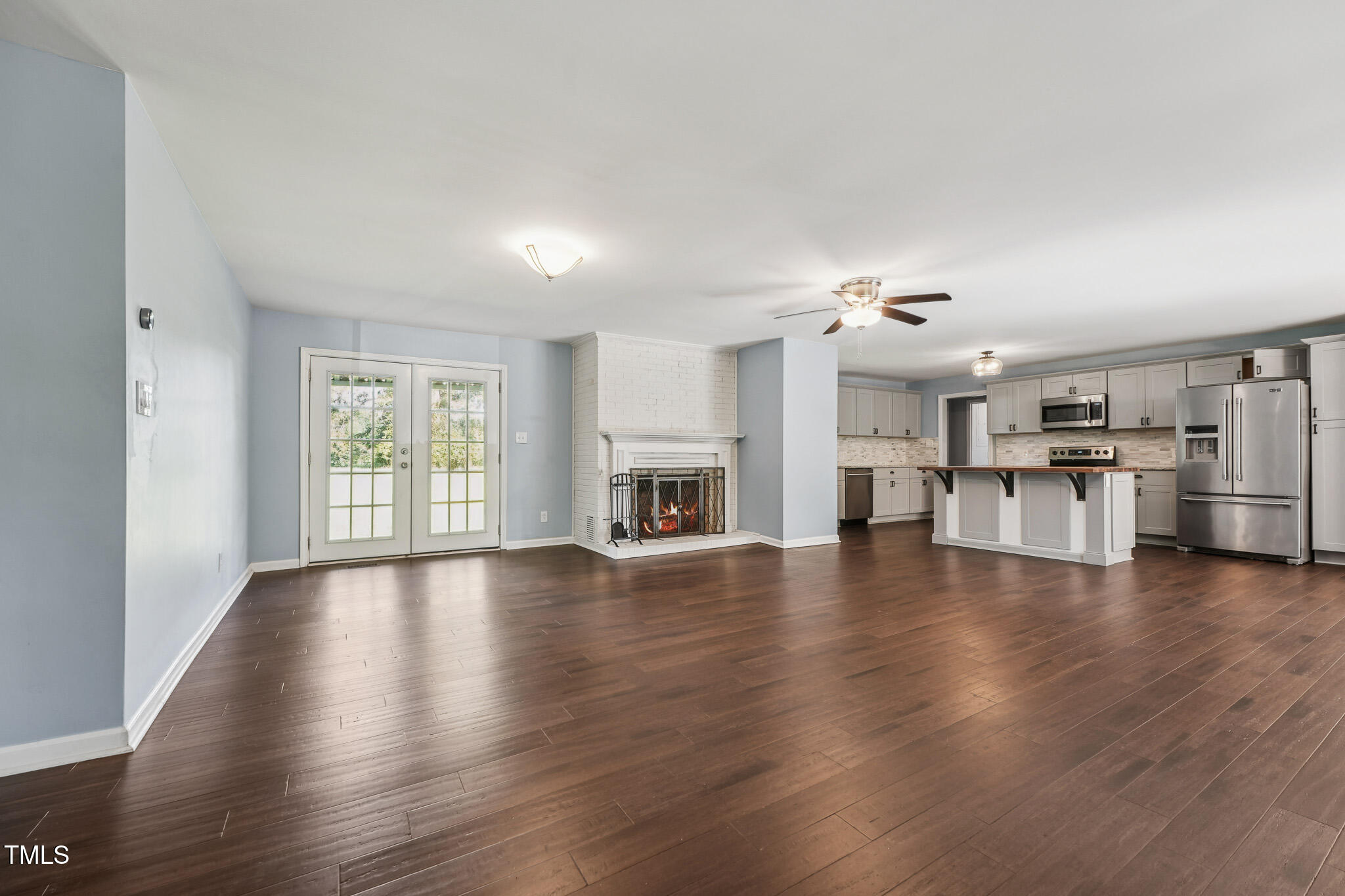 312 Mason Road Durham, NC 27712 - Photo 4 of 25 a view of empty room with wooden floor and fireplace