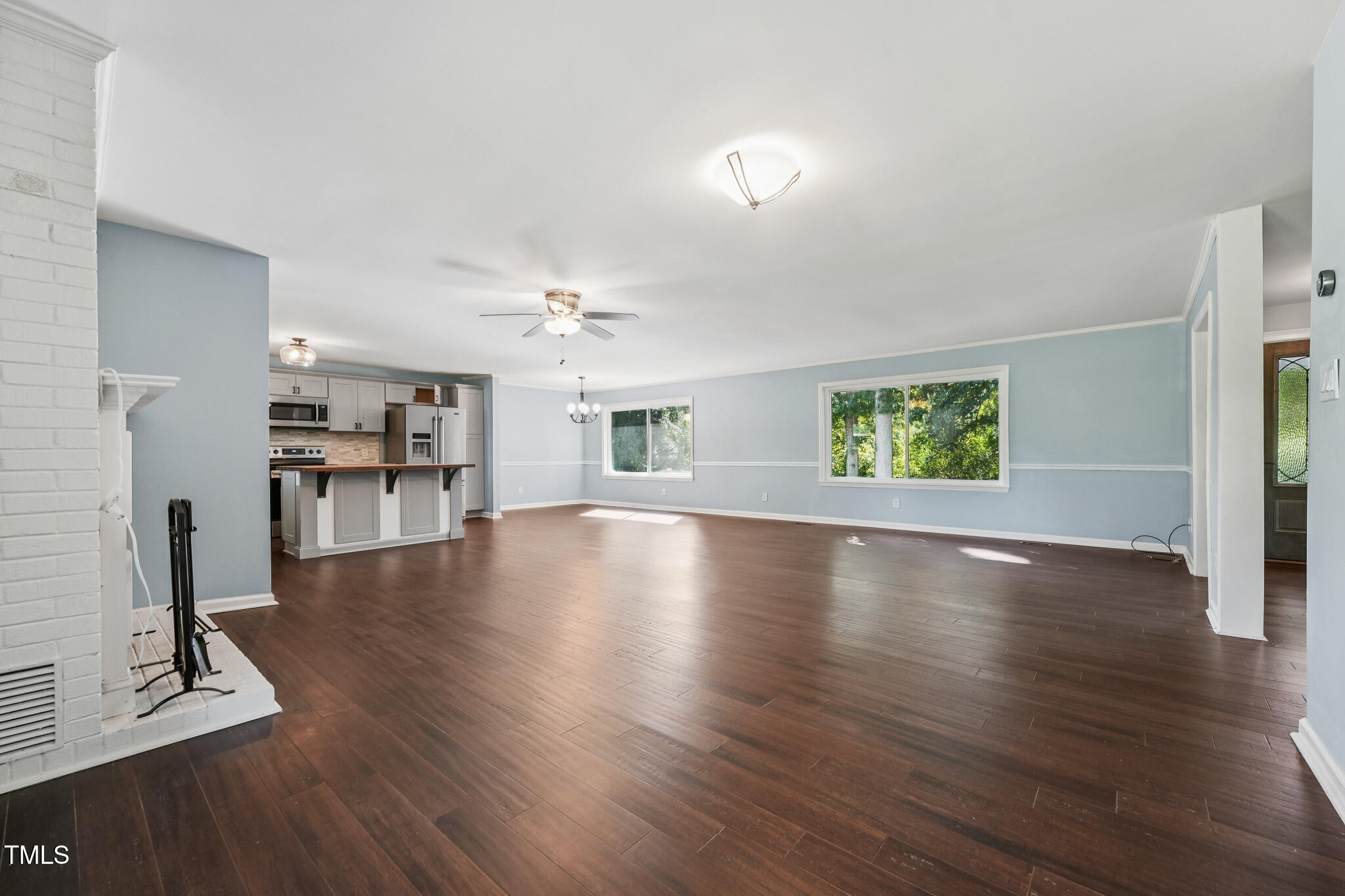 312 Mason Road Durham, NC 27712 - Photo 6 of 25 a view of an empty room with wooden floor and a window