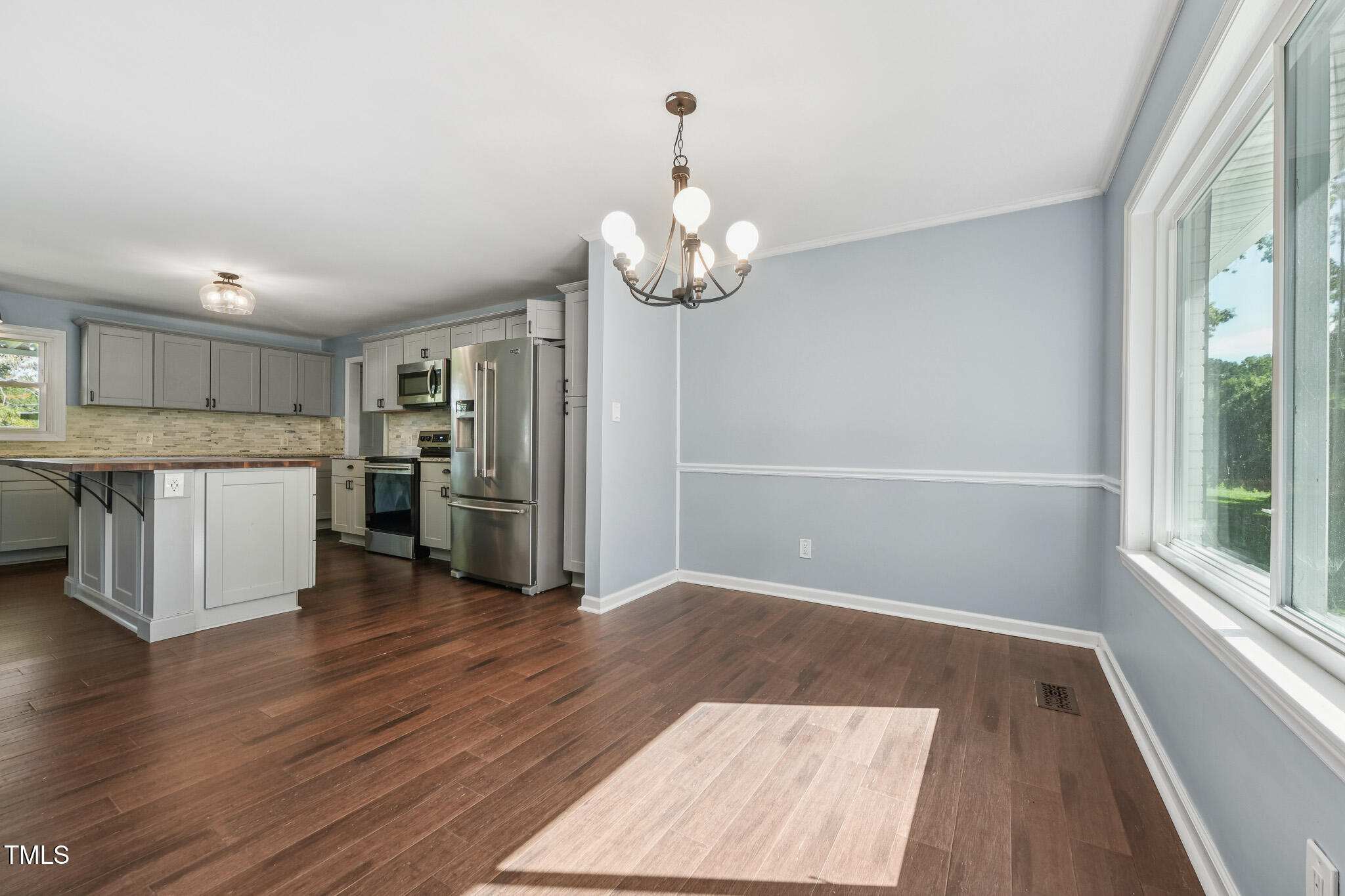 312 Mason Road Durham, NC 27712 - Photo 7 of 25 a kitchen with stainless steel appliances granite countertop a refrigerator and a stove top oven
