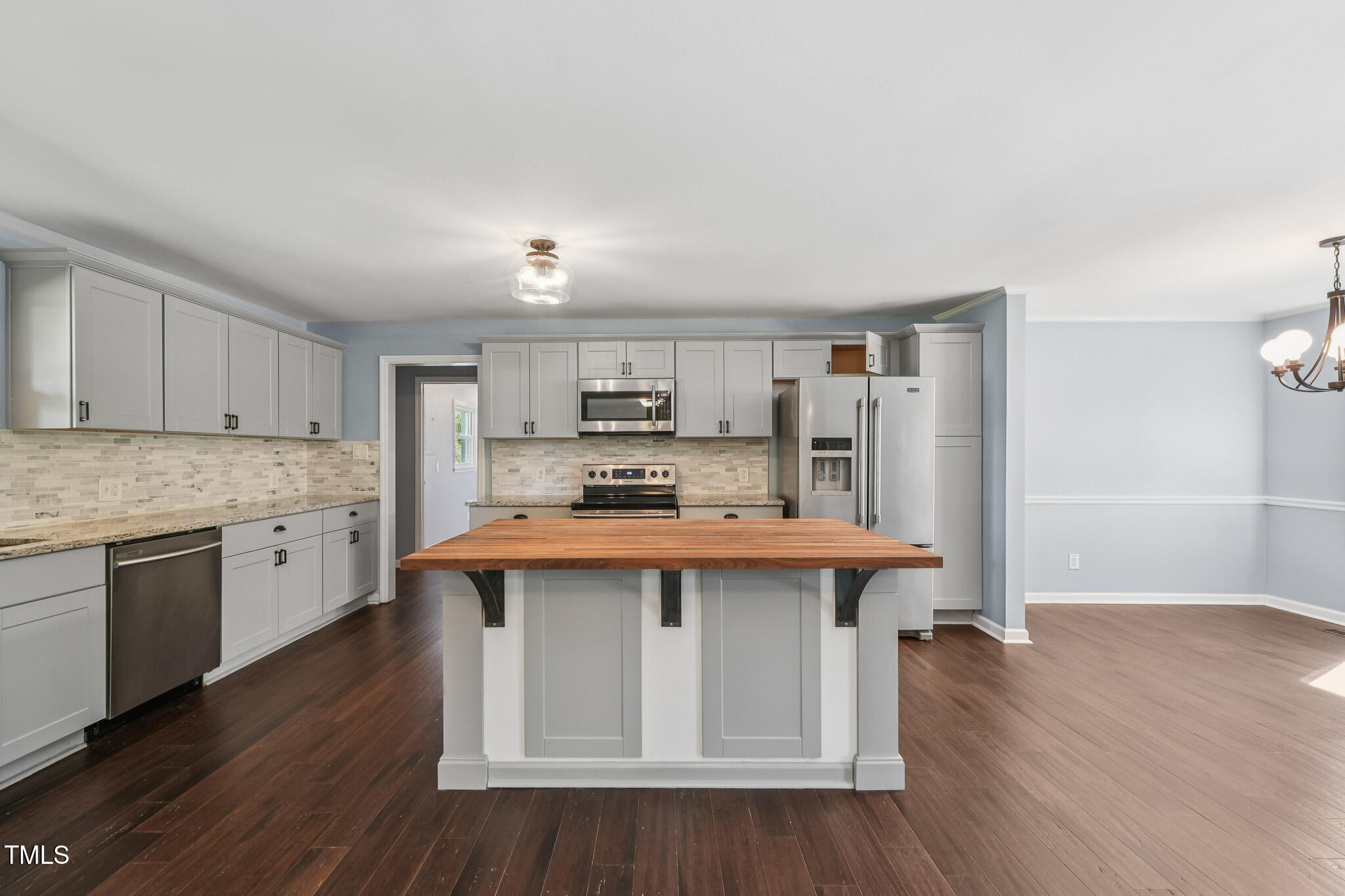 312 Mason Road Durham, NC 27712 - Photo 8 of 25 a large kitchen with cabinets wooden floor and stainless steel appliances