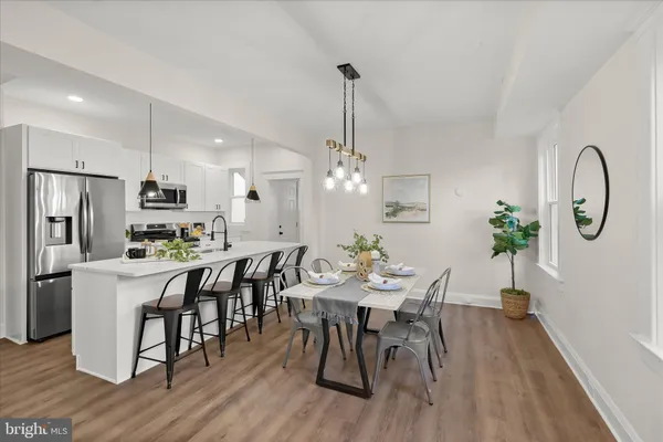 a living room with furniture and a dining table