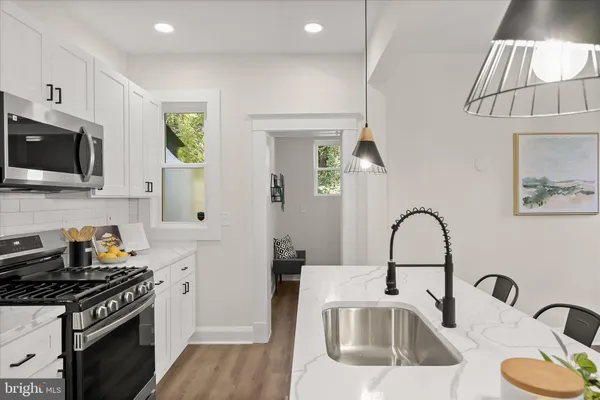 a kitchen with a sink cabinets and wooden floor