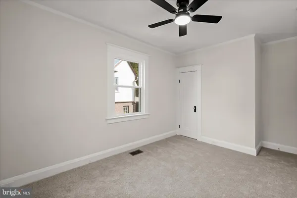 a view of room with window and ceiling fan