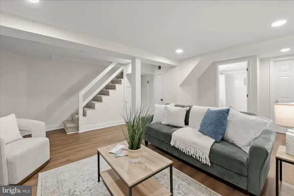 an empty room with chandelier fan and closet area