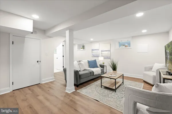 a living room with furniture and a potted plant