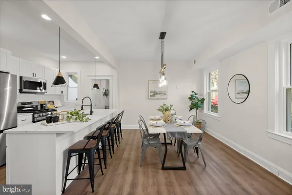 a view of a dining room with furniture window and wooden floor