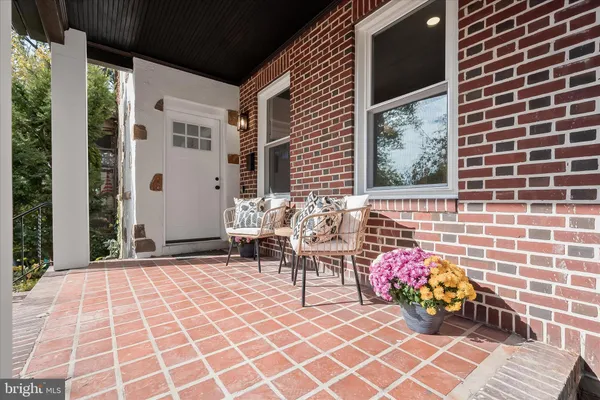 a view of a house with sitting area and garden