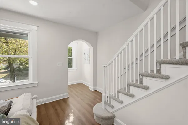 a view of entryway and hall with wooden floor