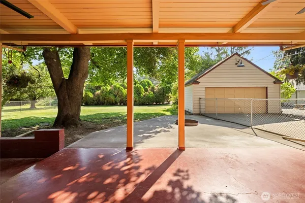 a view of a house with backyard and porch