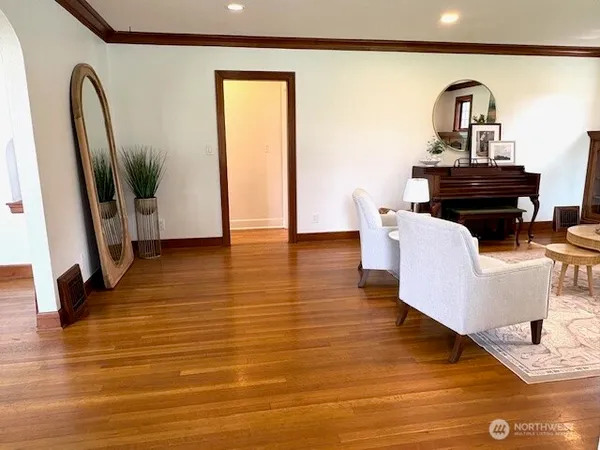 a living room with furniture and a mirror