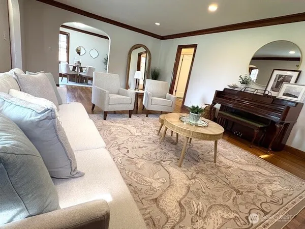 a living room with furniture and a piano