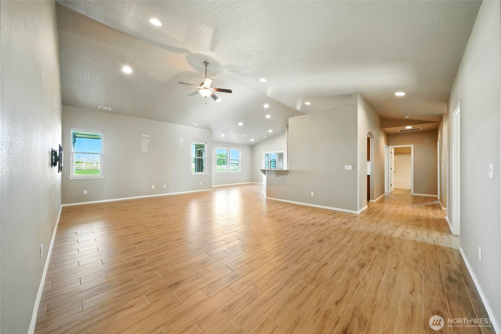 110 Shane Porter Road Walla Walla, WA 99362 - Photo 6 of 40 an empty room with wooden floor and windows