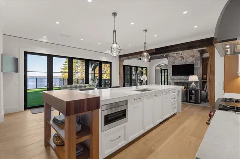 a bedroom with a large bed and a chandelier