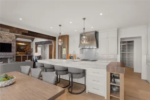 a bathroom with a sink shower and a mirror