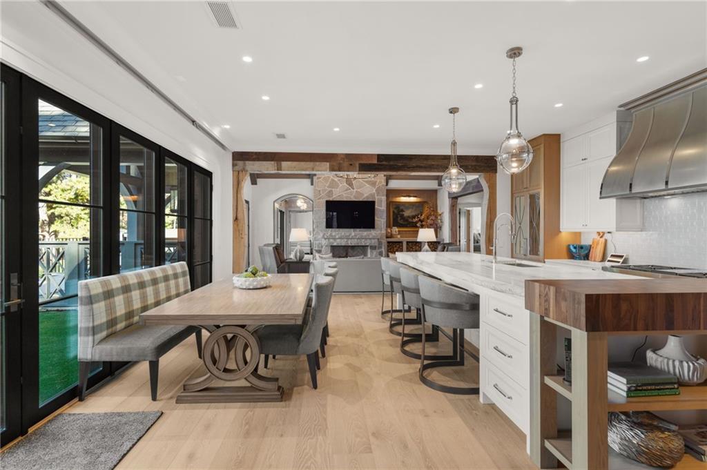 6091 GC Crow Road Flowery Branch, GA 30542 - Photo 19 of 100 a dining hall with stainless steel appliances kitchen island granite countertop a table chairs and a refrigerator