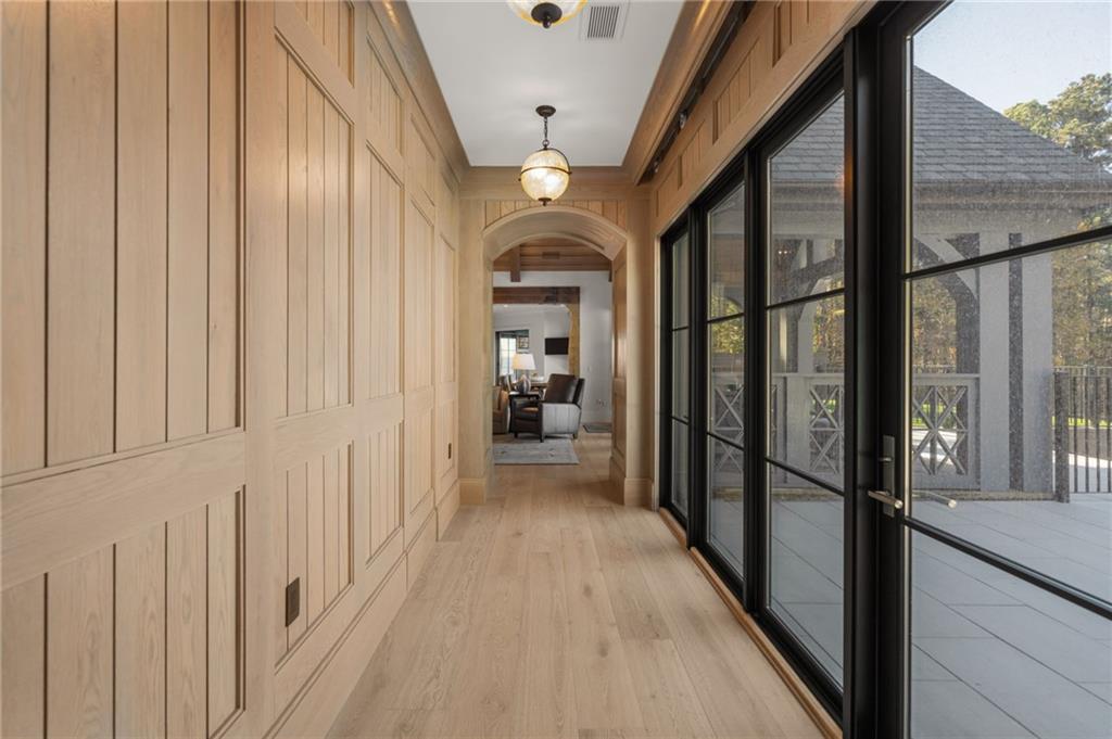 6091 GC Crow Road Flowery Branch, GA 30542 - Photo 24 of 100 a view of a hallway with wooden floor and staircase