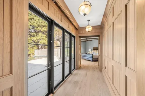 a view of a hallway with wooden floor and staircase