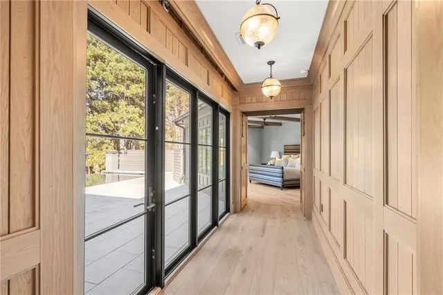 a view of a hallway with wooden floor and staircase