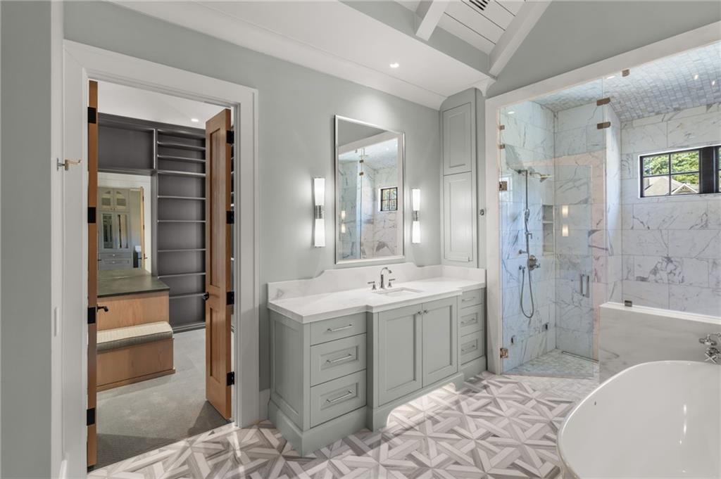 6091 GC Crow Road Flowery Branch, GA 30542 - Photo 28 of 100 a spacious bathroom with a bathtub shower sink mirror and toilet