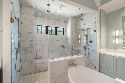 a bathroom with a sink and mirror with toilet