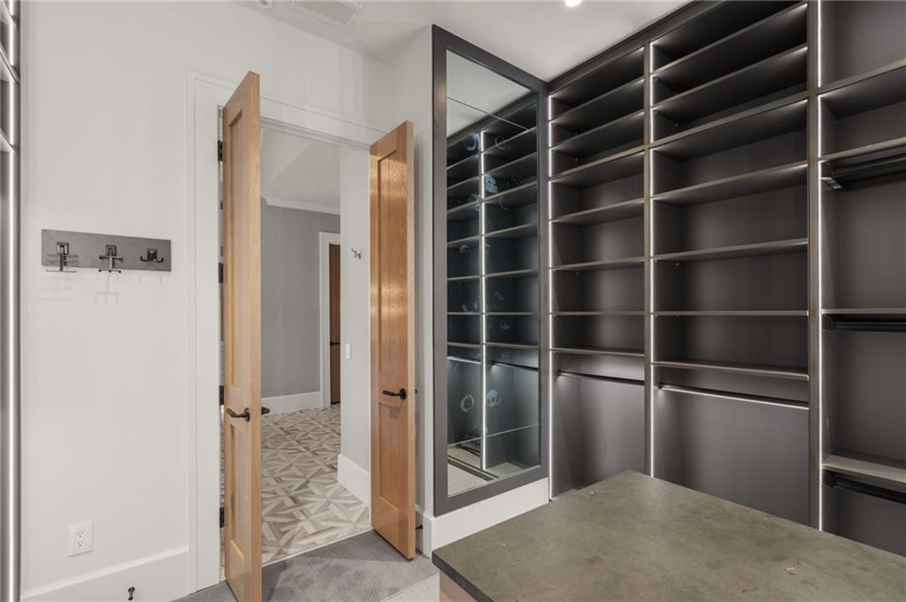 6091 GC Crow Road Flowery Branch, GA 30542 - Photo 33 of 100 a view of walk in closet with empty racks