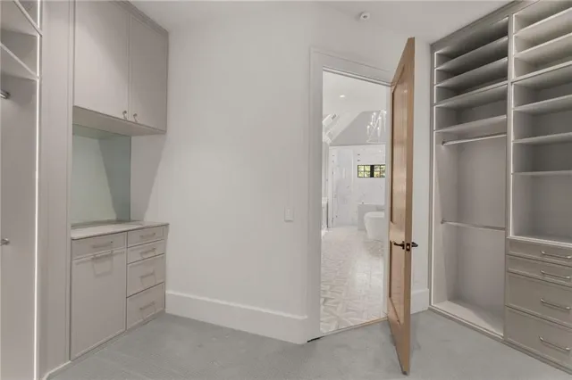 a kitchen with stainless steel appliances a dining table chairs and a refrigerator