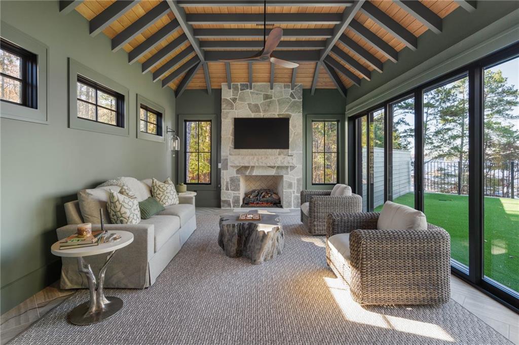 6091 GC Crow Road Flowery Branch, GA 30542 - Photo 40 of 100 a living room with furniture flat screen tv and a fireplace