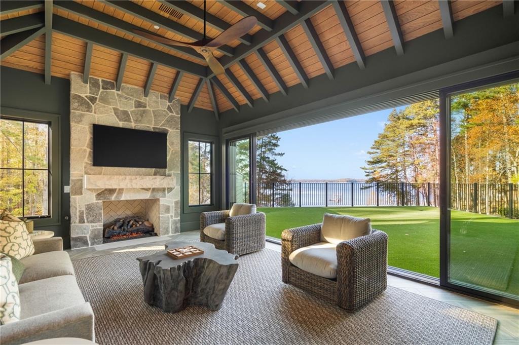 6091 GC Crow Road Flowery Branch, GA 30542 - Photo 41 of 100 a living room with furniture a flat screen tv and a fireplace