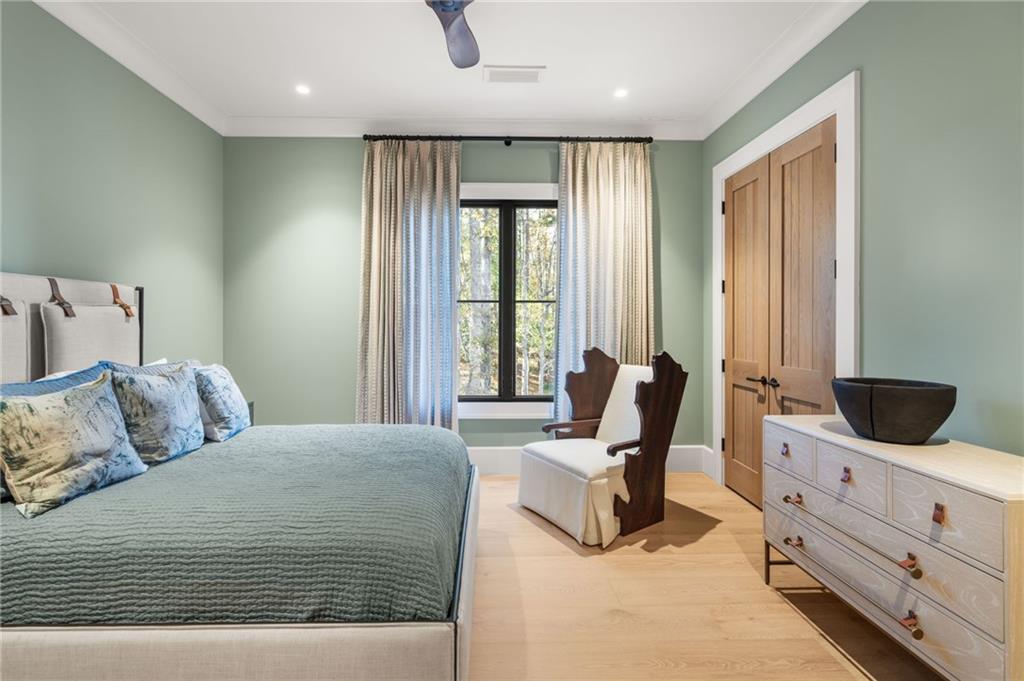 6091 GC Crow Road Flowery Branch, GA 30542 - Photo 43 of 100 a bedroom with a bed and glass windows