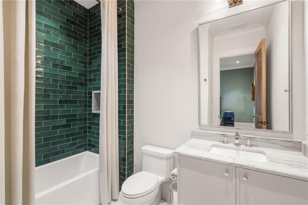 6091 GC Crow Road Flowery Branch, GA 30542 - Photo 45 of 100 a bathroom with a sink a toilet and shower