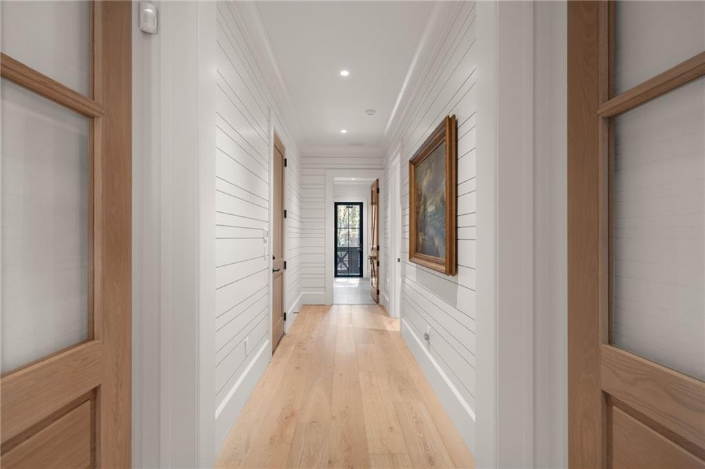 6091 GC Crow Road Flowery Branch, GA 30542 - Photo 46 of 100 a view of a hallway with wooden floor and staircase