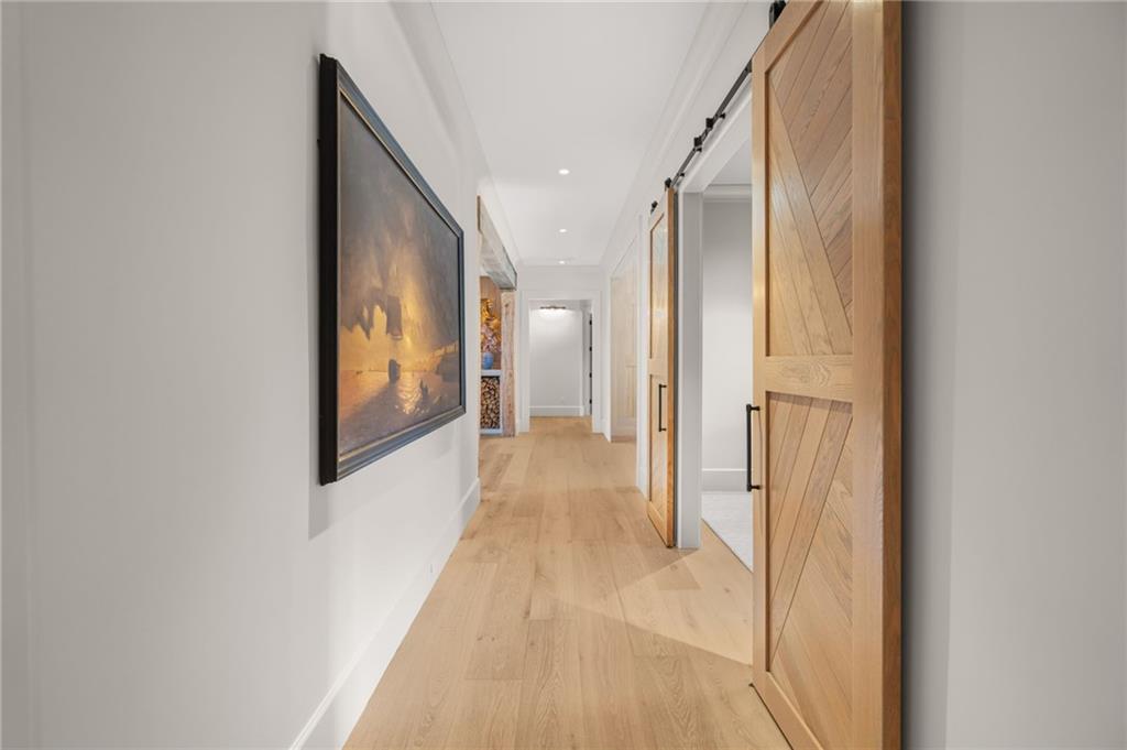 6091 GC Crow Road Flowery Branch, GA 30542 - Photo 47 of 100 a view of a hallway with wooden floor and staircase
