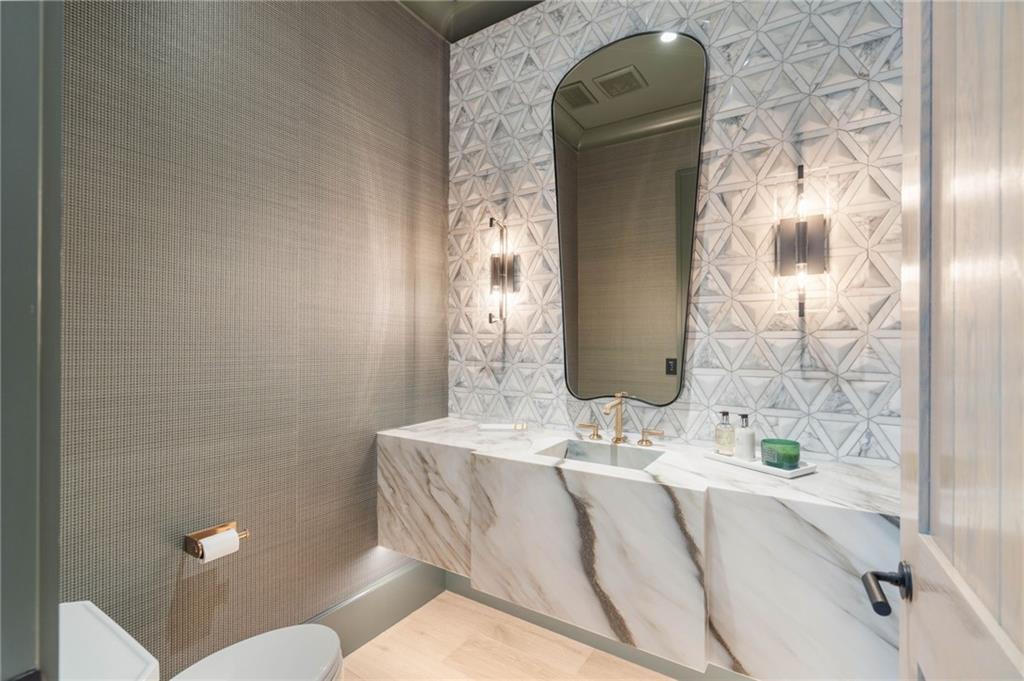 6091 GC Crow Road Flowery Branch, GA 30542 - Photo 54 of 100 a bathroom with a sink and mirror with toilet