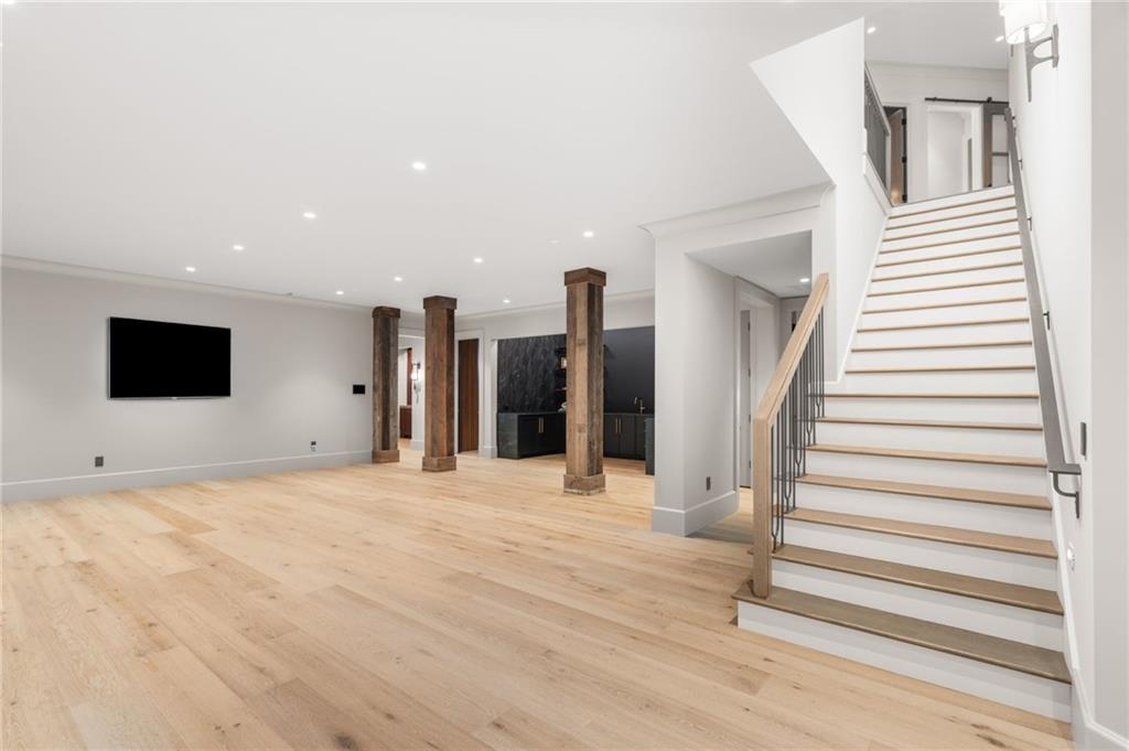 6091 GC Crow Road Flowery Branch, GA 30542 - Photo 62 of 100 a view of a livingroom with wooden floor and stairs