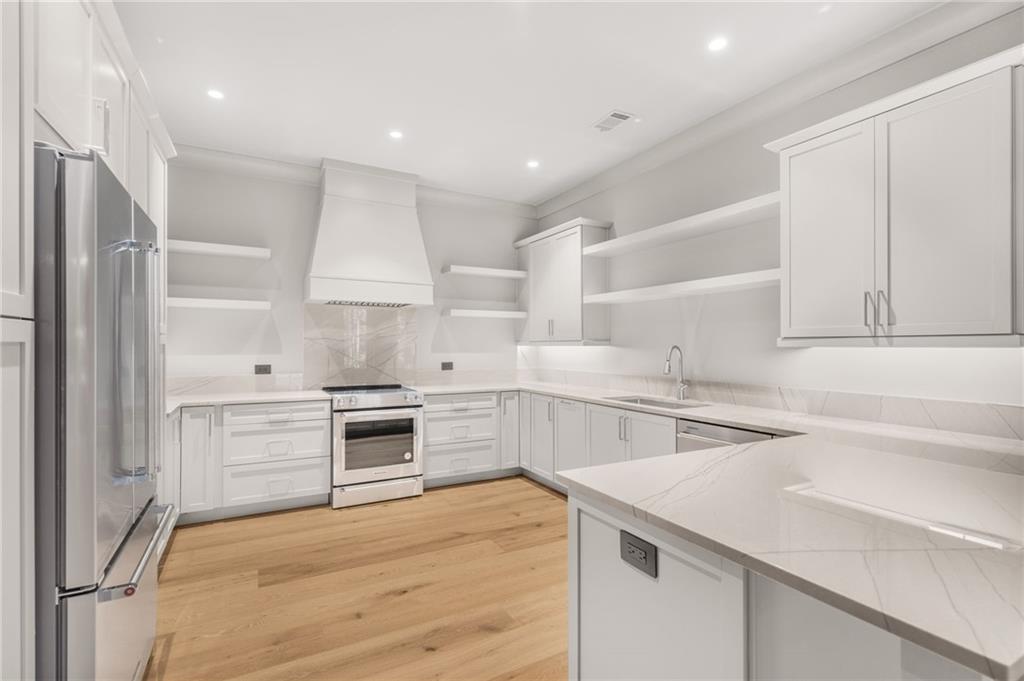 6091 GC Crow Road Flowery Branch, GA 30542 - Photo 76 of 100 a kitchen with a stove cabinets and a refrigerator