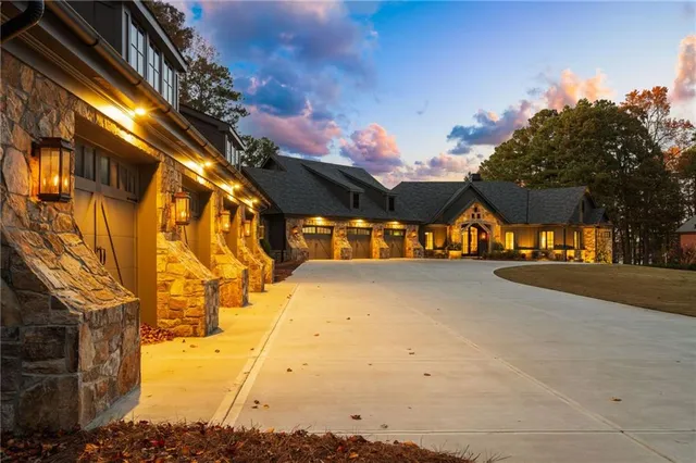 a dining hall with stainless steel appliances kitchen island granite countertop a table chairs and a refrigerator