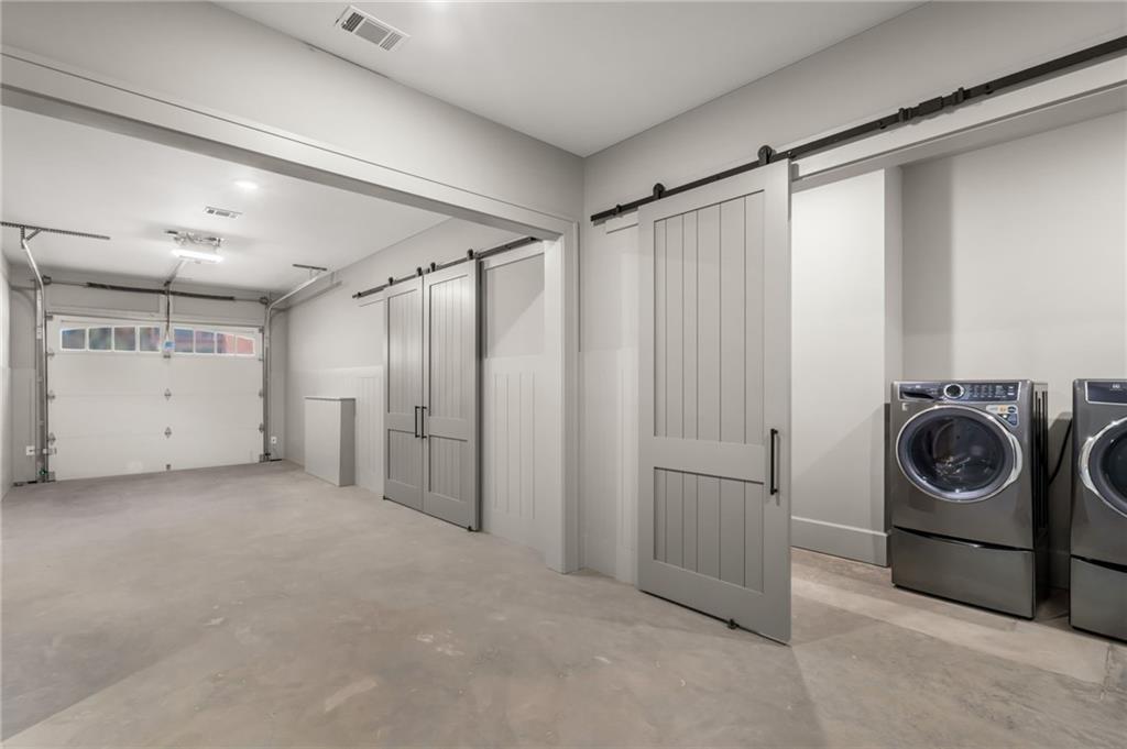 6091 GC Crow Road Flowery Branch, GA 30542 - Photo 81 of 100 a view of a storage & utility room with a washer dryer
