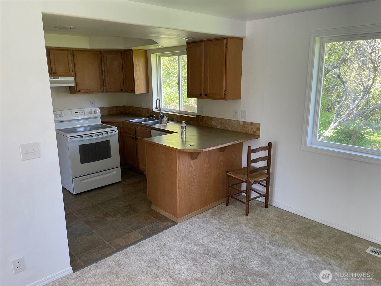 610 Rose Way Everett, WA 98203 - Photo 15 of 21 a kitchen with a stove a sink and a window