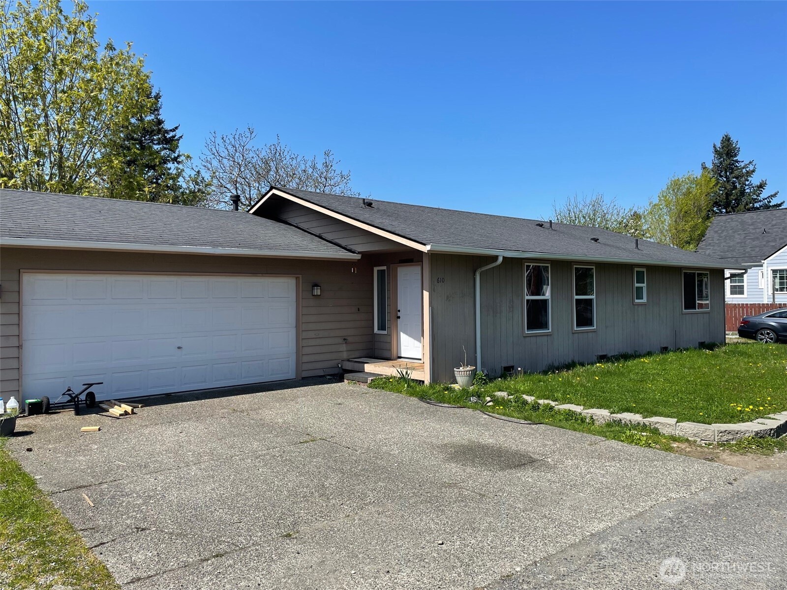 610 Rose Way Everett, WA 98203 - Photo 2 of 21 a front view of a house with a garden and trees