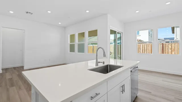 a view of kitchen with center island and stainless steel appliances