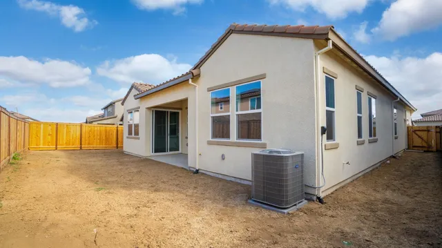 a backyard of a house with wooden fence