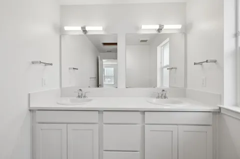 a bathroom with a sink vanity granite and a mirror