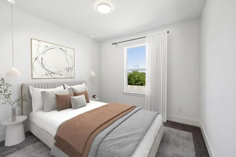 a bedroom with a bed and a window