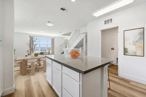 a kitchen with a sink cabinets and wooden floor