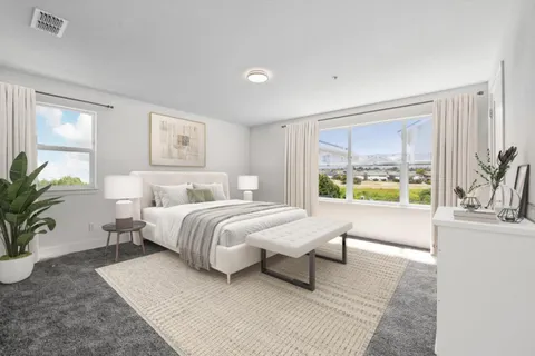 a bedroom with a bed and a large window