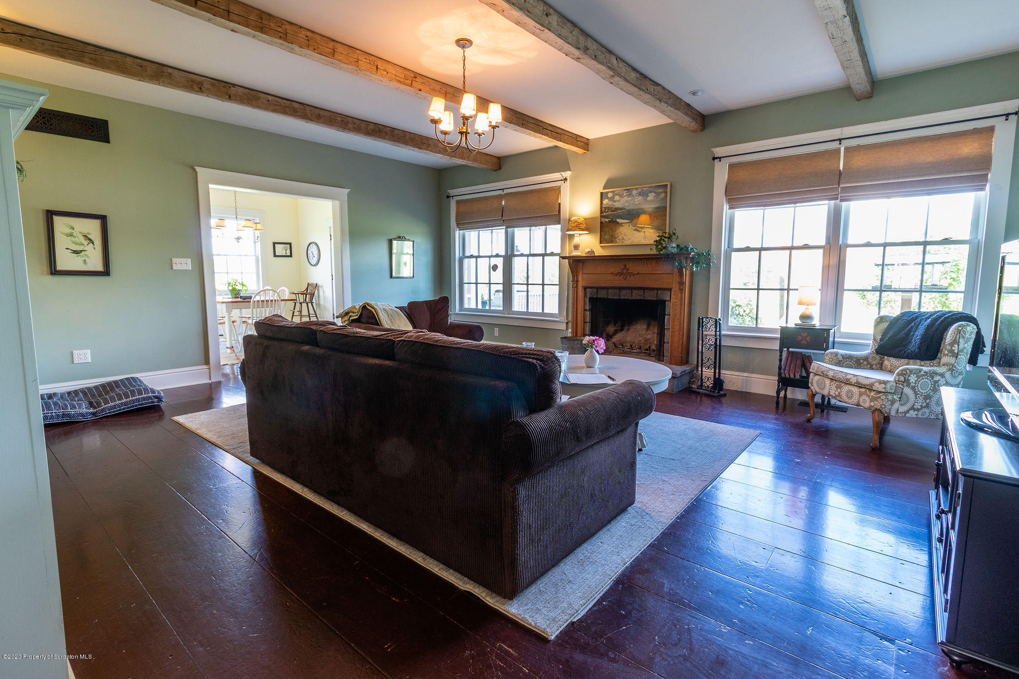 353 Freeman Road Dalton, PA 18414 - Photo 14 of 101 a living room with furniture a fireplace and a chandelier
