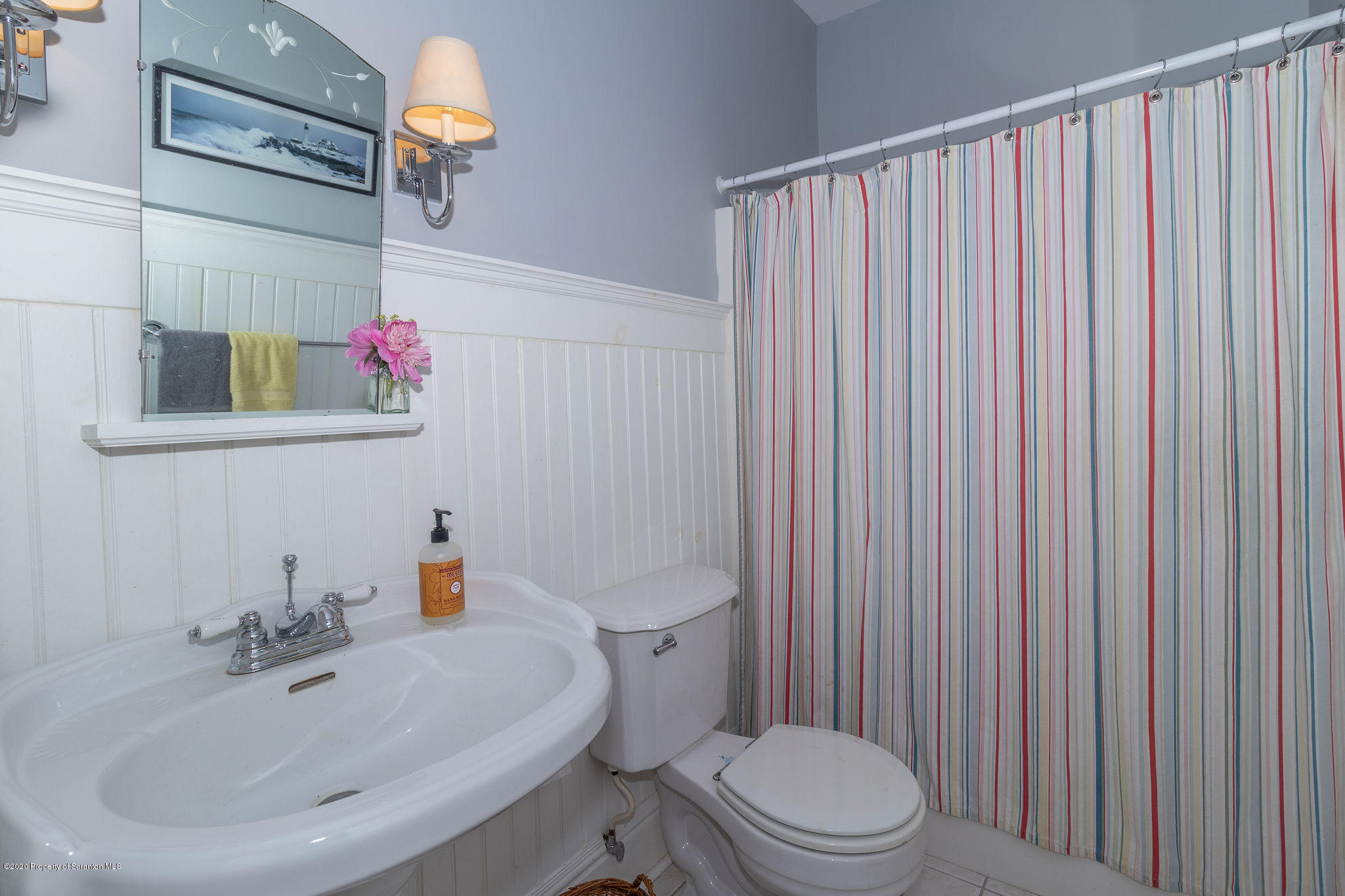 353 Freeman Road Dalton, PA 18414 - Photo 19 of 101 a bathroom with a sink a toilet and shower curtain