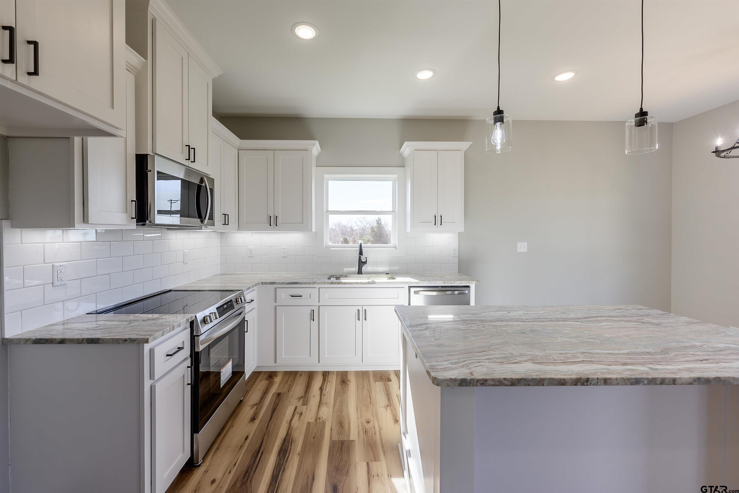 148 Crescent Bullard, TX 75757 - Photo 11 of 40 a kitchen with a sink stove and microwave