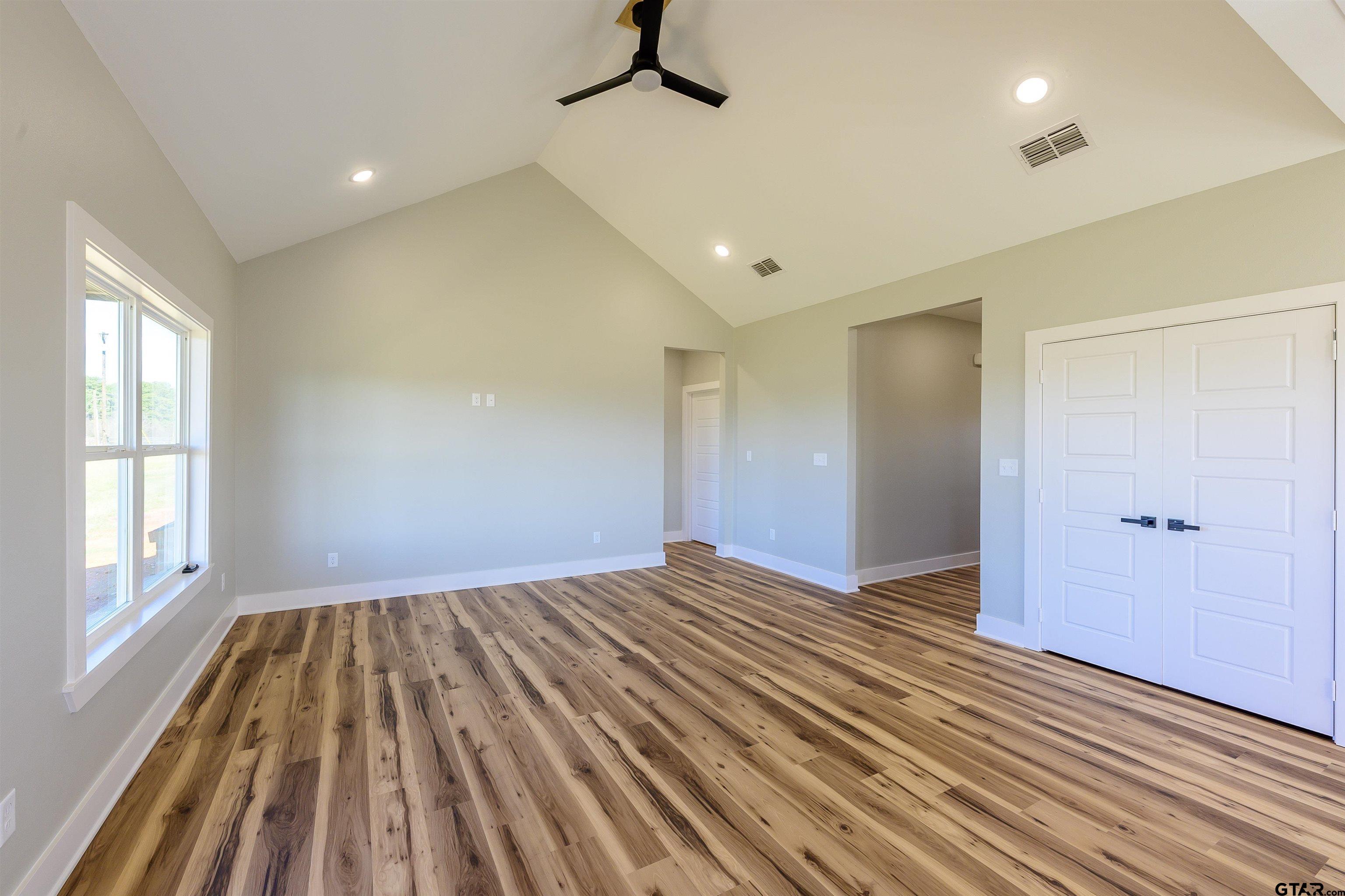 148 Crescent Bullard, TX 75757 - Photo 4 of 40 a view of empty room with wooden floor and windows